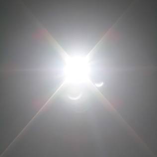 A flared image of the eclipse with the illusion of moons around it.